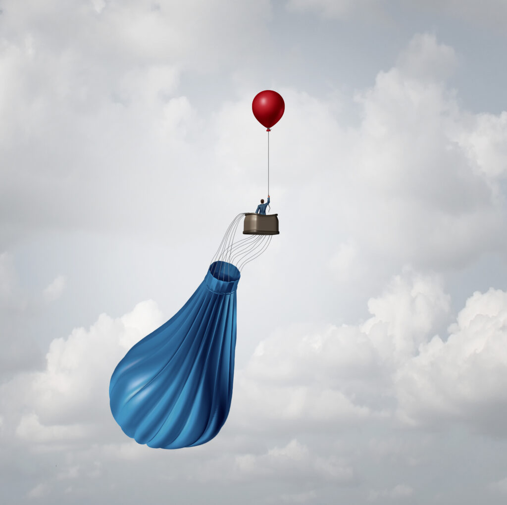 deflated-hot-air-balloon-with-basket-and-passenger-held-in-air-by-smaller-balloon
