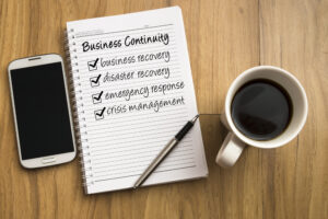business-continuity-notebook-with-pen-coffee-cup-and-smartphone
